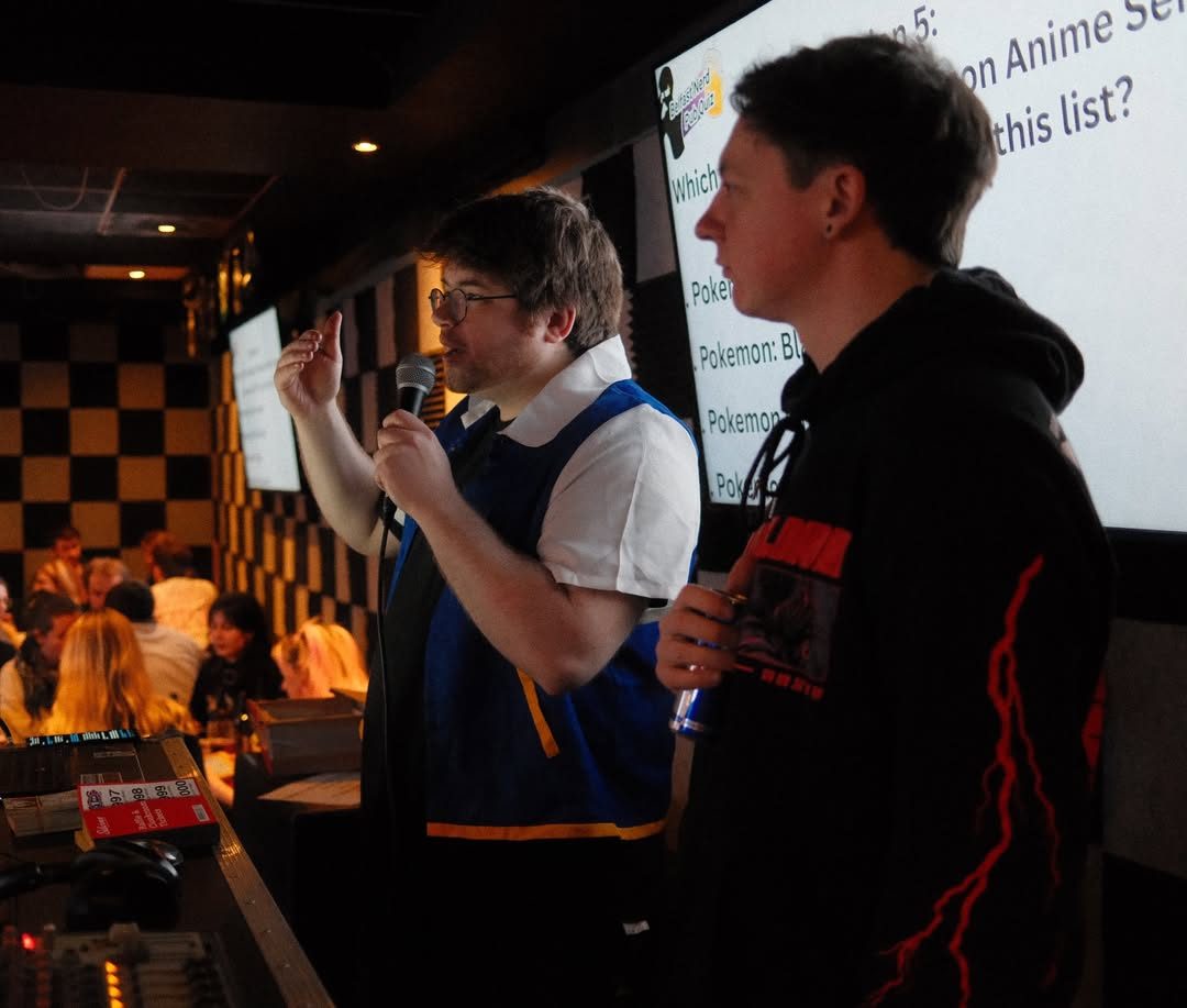 Quiz hosts presenting a round