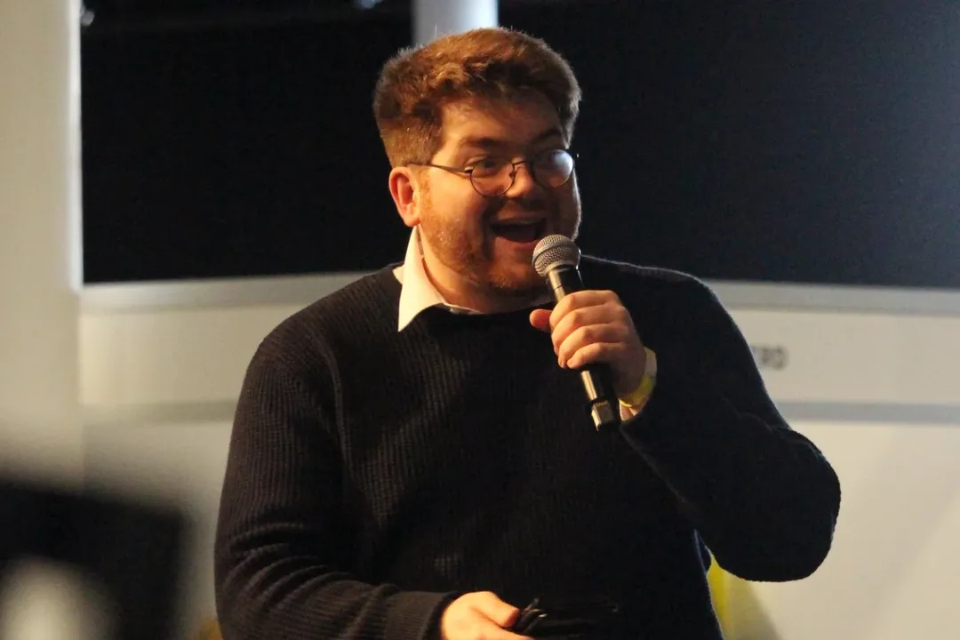 Callum speaking into a microphone