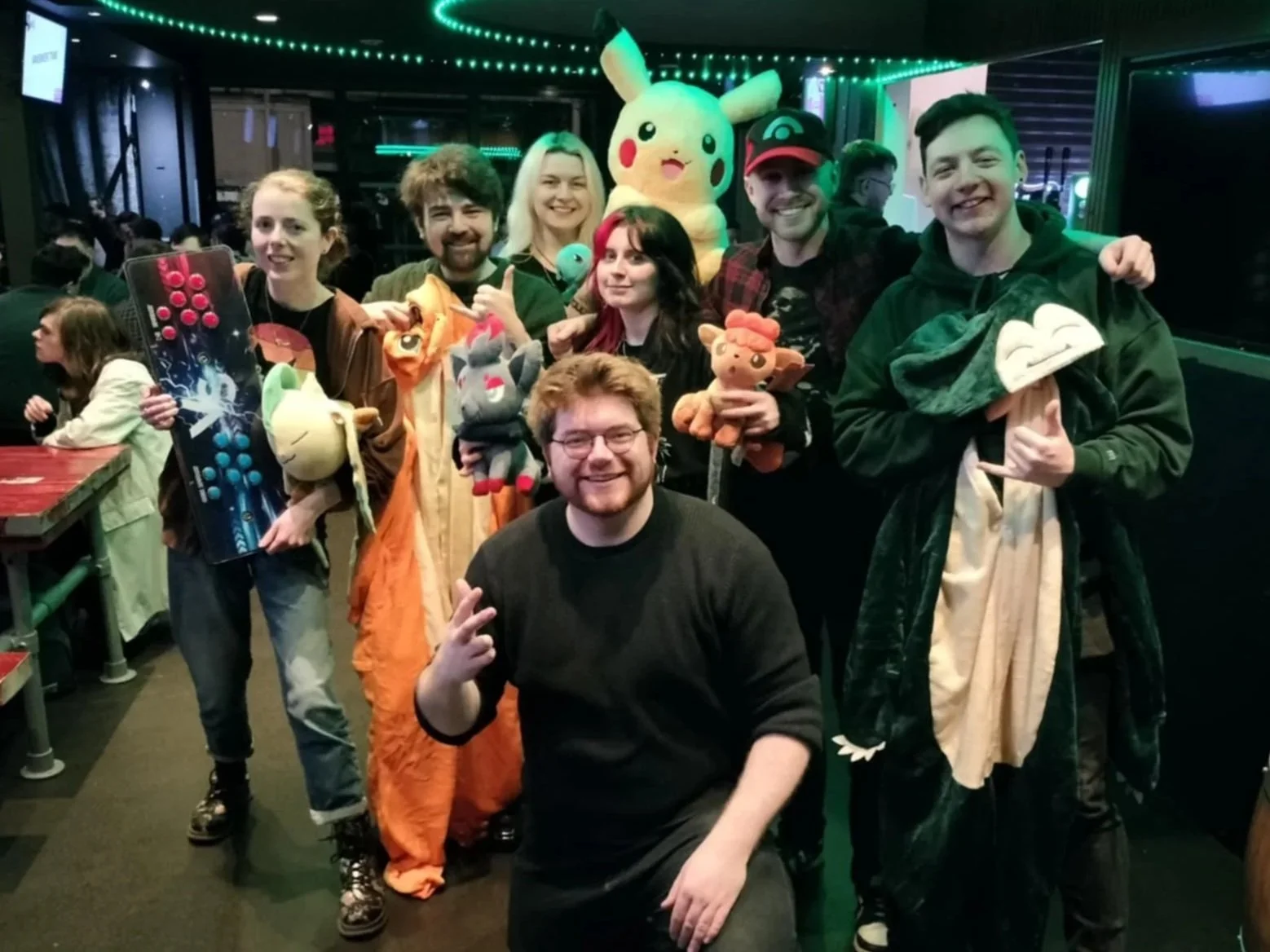 A winning Pokémon pub quiz team posing together