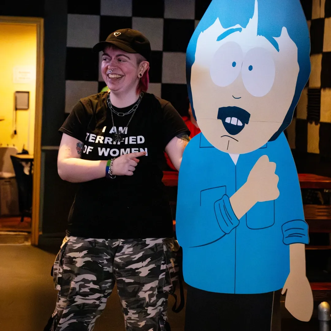 Laughing attendee beside a handmade cutout